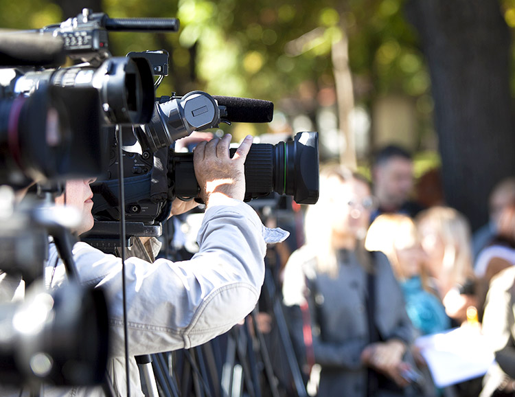 Media personel holding camera